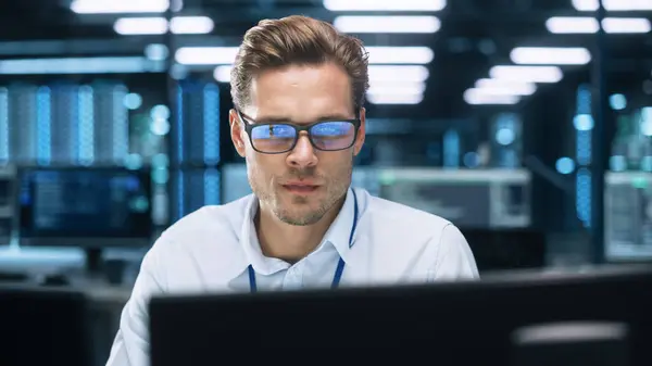 stock image Machine Learning Engineer or System Administration Programming at His Workstation. Man Plans and Carries Out Work to Expand the Network Structure of the Enterprise at His Office