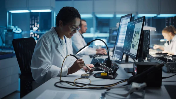 現代のエレクトロニクス研究 開発施設 黒い女性エンジニアは コンピュータのマザーボードはんだ付けします 科学者は産業用Pcb シリコンマイクロチップ 半導体を設計する — ストック写真