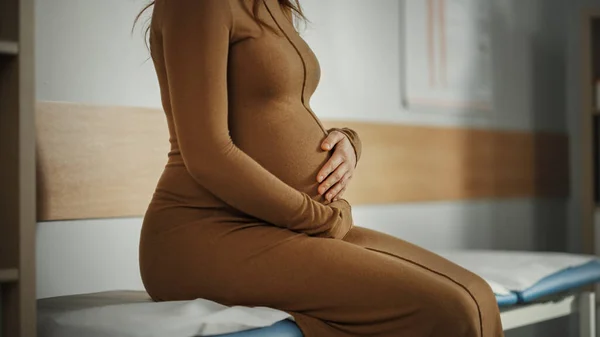 Young Female Patient Visiting a Modern Family Health Care Clinic. Pregnant Woman Waiting for Her Medical Test Results in Obstetrics and Gynecology Doctor\'s Hospital Office. Waiting for Physician.