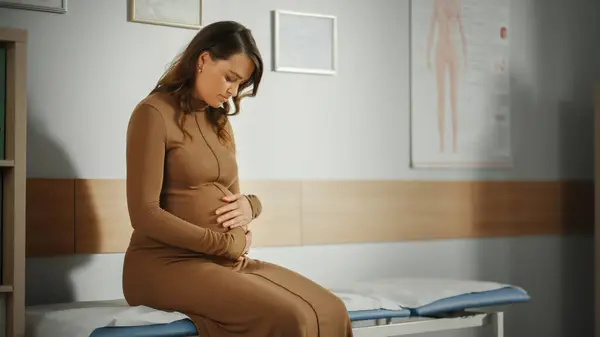 Young Female Patient Visiting a Modern Family Health Care Clinic. Pregnant Woman Waiting for Her Medical Test Results in Obstetrics and Gynecology Doctor\'s Hospital Office. Waiting for Physician.
