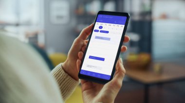 Güzel Otantik Kadın Kanepe üzerinde yatarken Evde Oturma Odasında Takvim Uygulaması ile Akıllı Telefon Kullanıyor. Planlar yapıyor ve bir günlük etkinlik programını kontrol ediyor..