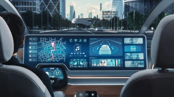 stock image Futuristic Concept: Stylish Businessman Using Navigation App on an Augmented Reality Dashboard with Financial News Broadcast while Sitting in an Autonomous Self-Driving Zero-Emissions Electric Car.