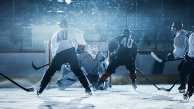 Ice Hockey Rink Arena: Professional Forward Player Masterfully Dribbles, Breaks Defense, Hitting Puck with Stick. Important and Tension Moment. clipart