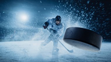 Ice Hockey Rink Arena: Professional Player Shooting the Puck with Hockey Stick. Focus on 3D Flying Puck with Blur Motion Effect. Dramatic Wide Shot, Cinematic Lighting. clipart