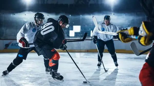 Ice Hockey Rink Arena: Professional Defender Player Attacks, Pushing Attacker Aggressively, Trying to take the Puck. Competitive Intense Game with Skill, Speed, Energy, Power.