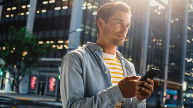 Çekici bir Japon kadın portresi. Üstü başı şık giyiniyor ve Şehir Caddesinde akıllı telefon kullanıyor. Büyük Şehir Yöneticisi Çevrimiçi İnsanlarla İletişim, Mesajlaşma ve İnternet Taraması.