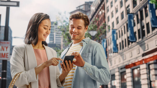 Portrait of an Attractive Japanese Female Wearing Smart Casual Clothes and Using Smartphone on the Urban Street. Manager in Big City Connecting with People Online, Messaging and Browsing Internet.