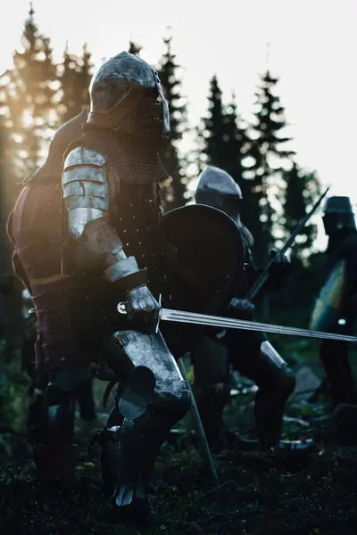 Epic Armies of Medieval Knights on Battlefield Clash, Plate Body Armored Warriors Fighting Swords in Battle. Bloody War and Savage Conquest. Historical Reenactment. Cinematic Shot