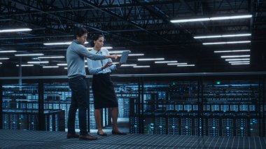 Veri Merkezi Kadın Sistem Yöneticisi ve Erkek Bilişim Uzmanı Konuşması, Laptop Bilgisayarı Kullan. Bilgi Teknolojisi Mühendisleri Bulut Bilgisayar Çiftliğinde Siber Güvenlik Ağ Koruması üzerine çalışıyor.