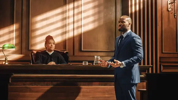 司法裁判所と法律裁判 男性の公的弁護士が訴訟を起こし 裁判官に情熱的なスピーチをする アフリカ系アメリカ人弁護士 弁護士 顧客の無実を守る 議論を支持する — ストック写真