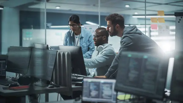 stock image Authentic Office: Enthusiastic Black IT Programmer Starts Working on Desktop Computer. Male Website Developer, Software Engineer Developing App, Video Game. Terminal with Coding Programming Language