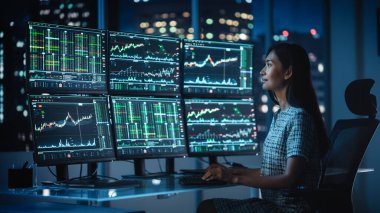 Finansal Analizci, Multi-Monitor Workstation ve Real-time Borsa ve Borsa Çizelgeleri ile bir bilgisayar üzerinde çalışıyor. Yatırım Komisyonculuğu Bürosu İş Kadınları Gecesi.