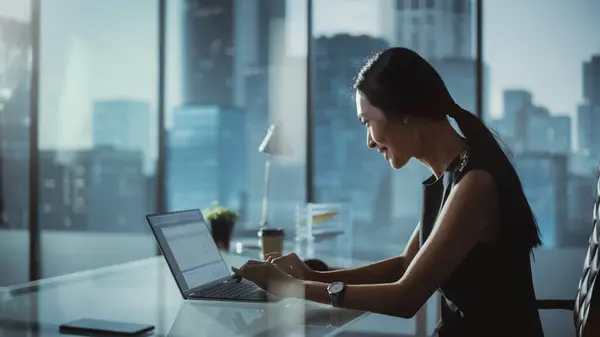 Successful Businesswoman Stylish Dress Sitting Desk Modern Office Using Laptop Stock Image