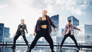 Modern Kentsel Skyline 'lı Büyük Dijital Led Wall Screen' in önünde Hip Hop Dansı yapan Üç Profesyonel Dansçı Grubu