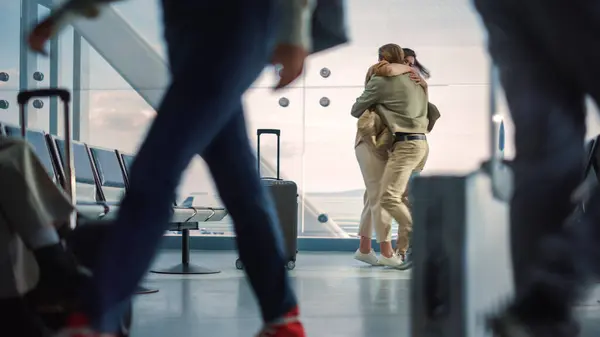 Airport Terminal Family Reunion: Beauitful Couple Meets at the Boarding Lounge. Smiling Girlfiend Meets the Love of Her Life after Long Parting and