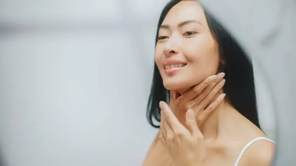 Portrait Beautiful Asian Woman Gently Applying Face Cream Looking Bathroom Stock Picture