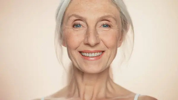 stock image Portrait of Senior Woman Looking at Camera, Smiling. Elderly Lady with Natural Grey Hair, Blue Eyes. Graceful of Old Age Concept for Skincare, Beauty