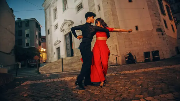 Beautiful Couple Dancing a Latin Dance on the Quiet Street of an Old Town in a City. Sensual Dance by Two Professional Dancers in the Evening in