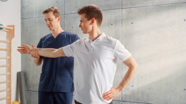 Professional Physiotherapist Working on Specific Muscle Groups and Back Pain with Young Male Athlete. Succesfull Sportsman Recovering from Mild Injury