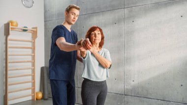 Professional Sport Physiotherapist Working on Specific Muscle Groups and Back Pain with Middle Aged Sporty Female. Senior Woman Treating Mild Injury