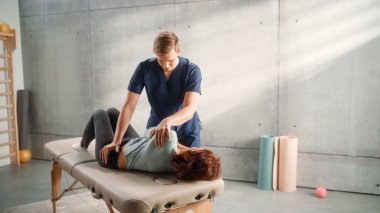 Middle Aged Fit Female Undergoing Physiotherapy, Professional Sport Masseur Treating Light Muscle or Back Trauma. Musculoskeletal Pain Therapy and