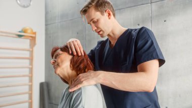 Professional Sport Physiotherapist Working on Specific Muscle Groups and Neck Pain with Middle Aged Fit Female. Senior Woman Recovering from Mild