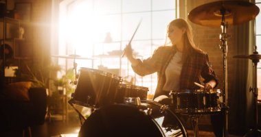 Portrait of a Beautiful Young Drummer Playing at a Band Rehearsal, Doing Tricks with Drumsticks. Learning Drum Solo on Drums and Cymbals in Sunny