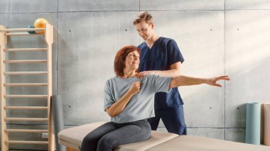 Advanced Sport Physiotherapy Specialist Stretching and Working on Specific Muscle Groups or Joints with Elderly Woman. MIddle Aged Female Recovering