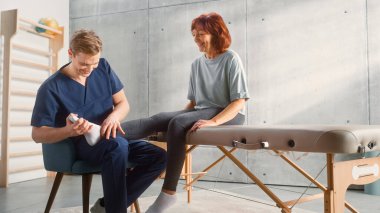 Middle Aged Fit Female Undergoing Professional Physiotherapy, Sport Masseur Treating Light Muscle or Joint Injury. Musculoskeletal Pain Relief and