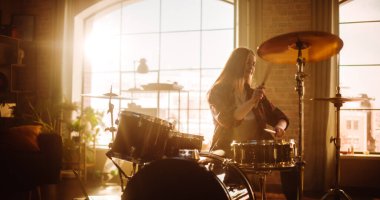 Portrait of a Beautiful Young Drummer Playing at a Band Rehearsal, Doing Tricks with Drumsticks. Learning Drum Solo on Drums and Cymbals in Living