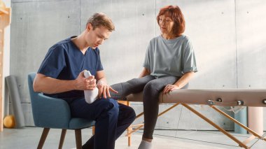 Middle Aged Fit Female Undergoing Physiotherapy, Professional Sport Masseur Treating Light Muscle or Joint Injury. Musculoskeletal Pain Relief and