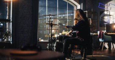 Portrait of a Young Drummer Playing at a Band Rehearsal, Doing Tricks with Drumsticks. Learning Drum Solo on Drums and Cymbals in Living Room Loft
