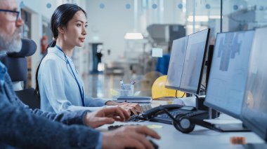 Factory Office Facility: Industrial Engineers Drafting Blueprints of a Heavy Industry Machine Parts on a Computer CAD Software. Modern Technological