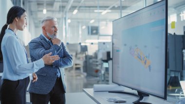 Factory Office Meeting: Chief Engineer Talking with Business Partner in a Conference Room with TV with Green Screen Mock Up Display. Concept for Heavy