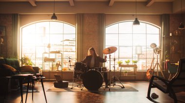 Beautiful Young Drummer Playing at a Band Rehearsal, Doing Tricks with Drumsticks. Learning Drum Solo on Drums and Cymbals in Sunny Living Room of