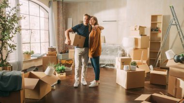 Family New Home Moving in: Happy and Excited Young Couple Enter Newly Purchased Apartment. Beautiful Family Happily Embracing, Imagining Future