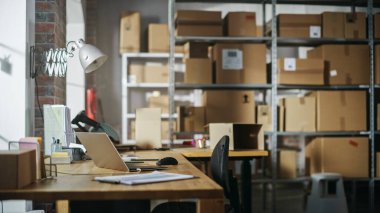 Establishing Shot of a Warehouse Worker at Work in Internet Shops Storeroom. Small Business Owner or Managers Preparing Parcels for Delivery