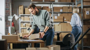 Multicultural Team of Warehouse Employees at Work in Retail Shops Storeroom. Small Business Owners and Inventory Managers Working on Laptop, Packing