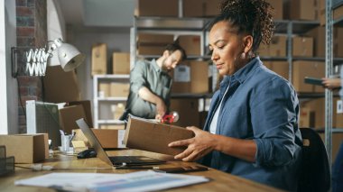 Multicultural Team of Warehouse Employees at Work in Retail Shops Storeroom. Small Business Owners and Inventory Managers Working on Laptop, Tablet