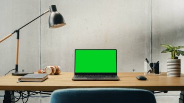 Laptop Computer with Mock Up Green Screen Display Standing on a Desk. Efficiently Minimalistic Design of Modern Office Space That Guarantees Harmony