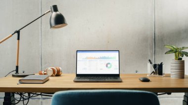Laptop Computer with Software Platform Screen Display Standing on a Desk. Efficiently Minimalistic Design of Modern Office Space. Economy, Finances