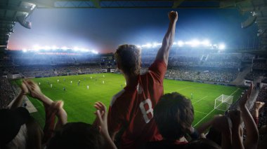 Futbol Şampiyonası Maçı sırasında Stadyumda Taraftarları için Tezahürat Çekimi. Takımlar oynar, Taraftarlar Çığlık atar, Zaferi Kutlar