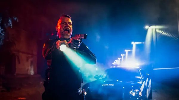 stock image Portrait of Professional Police Officer Unholsters His Gun and Starts Aiming it at Criminal, Orders to Stop Resisting Arrest. Get On the ground. Hands