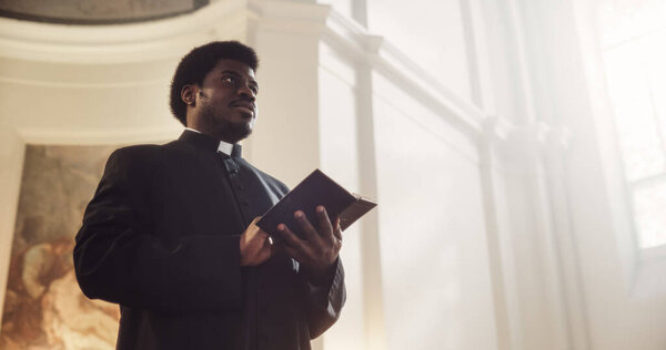 In Christian Church: Protestant Minister Leads Congregation In Prayer, Reads From The Holy Book, The Bible, Gospel of Jesus. Portrait of Priest Doing