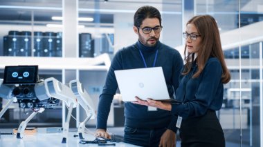 Profesyonel Kadın ve Erkek Mühendisler Çok Kültürlü Ekibi Fabrika Geliştirme Atölyesinde Endüstriyel Programlanabilir Robot Köpek Üzerinde Çalışıyor. Teknoloji