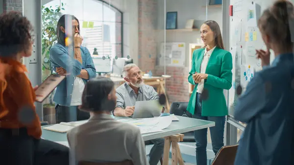 stock image Woman Doing a Presentation in a Meeting Room at Office With her Team. Female Excutive Manager Presenting Company Growth Data and Marketing Strategy