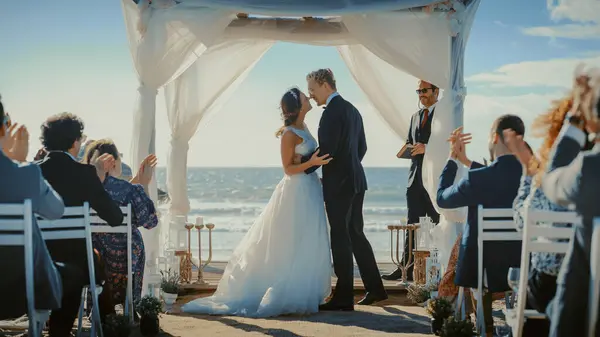 stock image Beautiful Bride and Groom During an Outdoors Wedding Ceremony on an Ocean Beach. Perfect Venue for Romantic Couple to Get Married, Exchange Rings