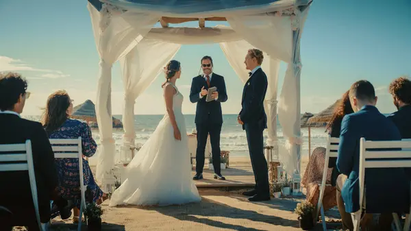 Stock image Beautiful Bride and Groom During an Outdoors Wedding Ceremony on a Beach Near the Ocean. Perfect Venue for Romantic Couple to Get Married, Kiss and