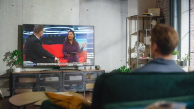 Genç ve yakışıklı bir adam rahat bir şekilde koltukta oturuyor ve hafta sonu boyunca canlı talk show seyrediyor. Ciddi Dişi Afrikalı