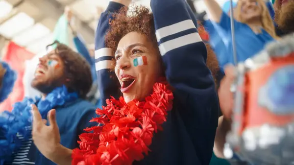 stock image Sport Stadium Soccer Match: Portrait of Beautiful Bi Racial Fan Girl with Italian Flag Painted Face Cheering Team to Win, Beating Tambourine. Crowd